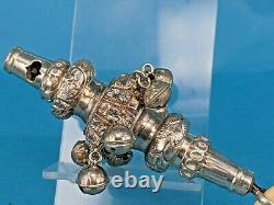 A Victorian silver rattle a whistle round soother & seven silver bells 1895