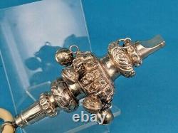 A Victorian silver rattle a whistle round soother & seven silver bells 1895