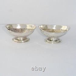 A solid silver pair of Victorian boat-shaped pedestal salts, London 1888