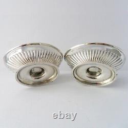 A solid silver pair of Victorian boat-shaped pedestal salts, London 1888