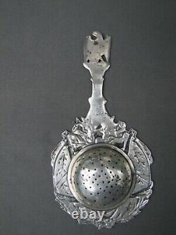 Antique sterling silver military motif tea strainer