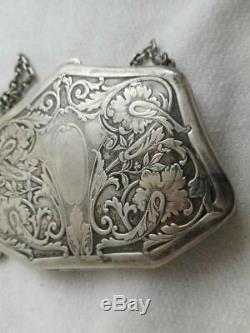 Signed A Victorian chased sterling silver purse with taffeta lining coin area