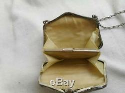 Signed A Victorian chased sterling silver purse with taffeta lining coin area