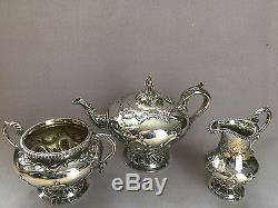 Victorian silver three piece tea set with repousse scrolled decoration 1838