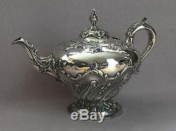 Victorian silver three piece tea set with repousse scrolled decoration 1838